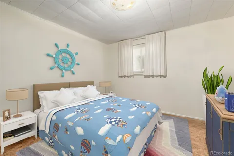 a bedroom with a bed and a potted plant