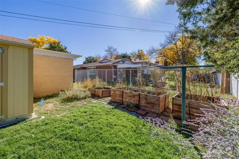 a view of a chair and table in backyard of the house