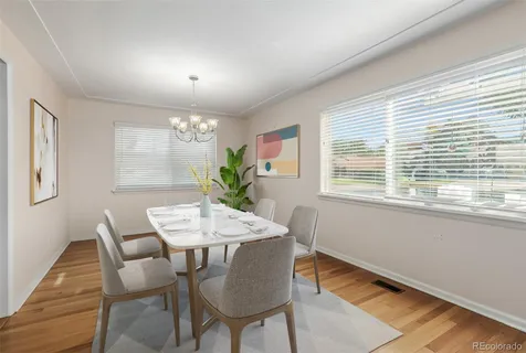 a dining room with furniture and window
