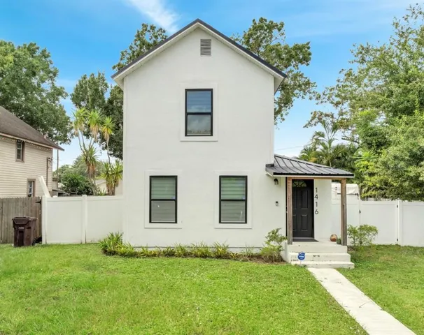 a view of an house with backyard space and garden
