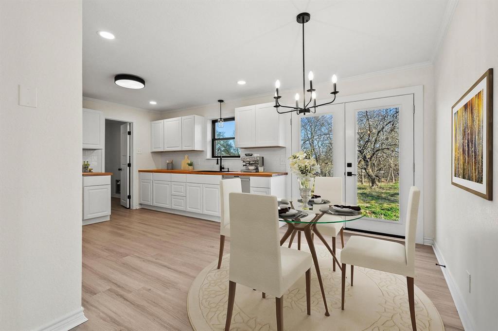 2760 Fm 1897 Bells, TX 75414 - Photo 9 of 34 a kitchen with stainless steel appliances kitchen island granite countertop a table chairs and a refrigerator