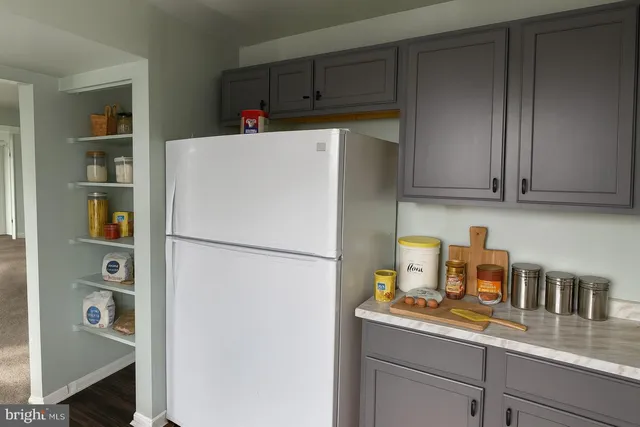 a bathroom with a granite countertop toilet sink and mirror