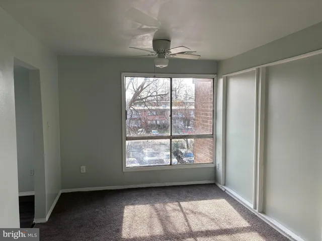 a bedroom with a bed and a flat tv screen on the dresser