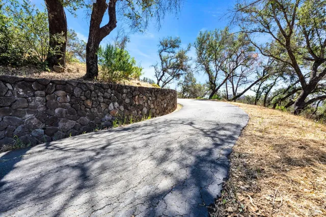 a view of a yard covered with snow in front of house