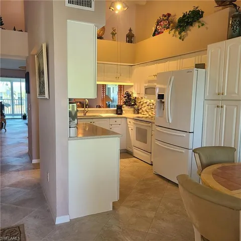 a kitchen with stainless steel appliances granite countertop a refrigerator a stove a sink and dishwasher