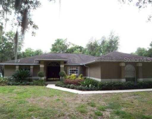 2105 Nichols Road Lithia, FL 33547 - Photo 1 of 1 a front view of house with yard and outdoor seating