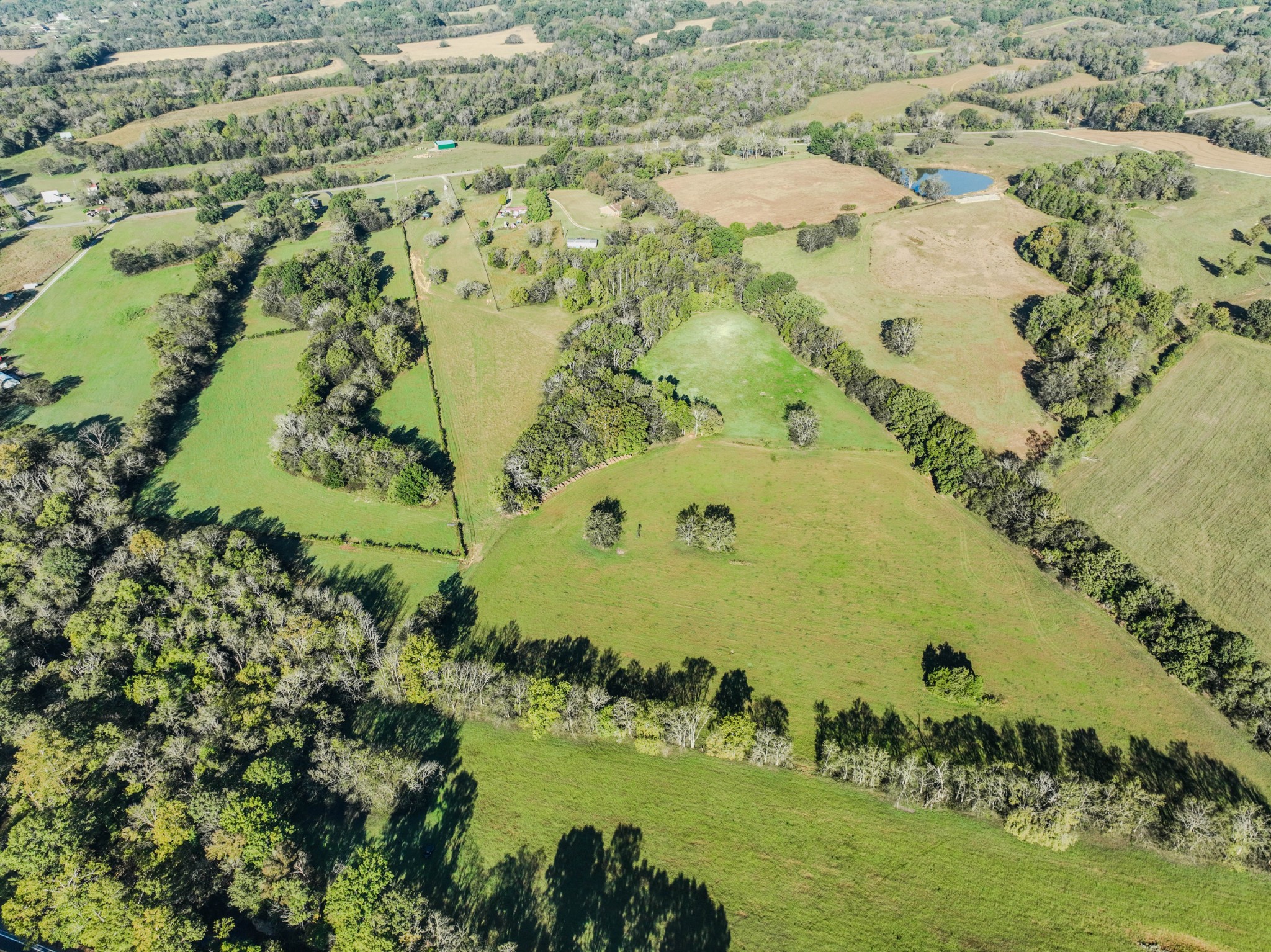 an aerial view of a house with a yard and lake view