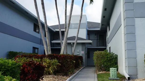 a view of a hallway with wooden floor and windows