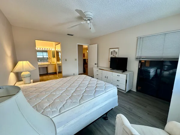 a bedroom with two beds and a chandelier