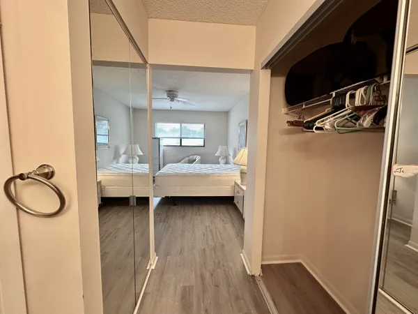 a view of a house with a yard porch and a tree