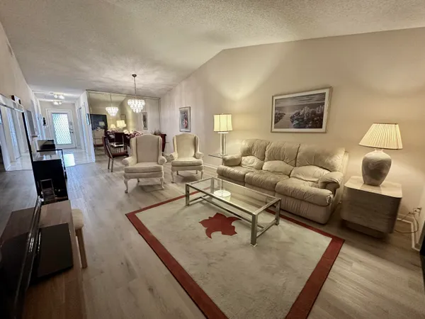 a bathroom with a sink a toilet a mirror and shower