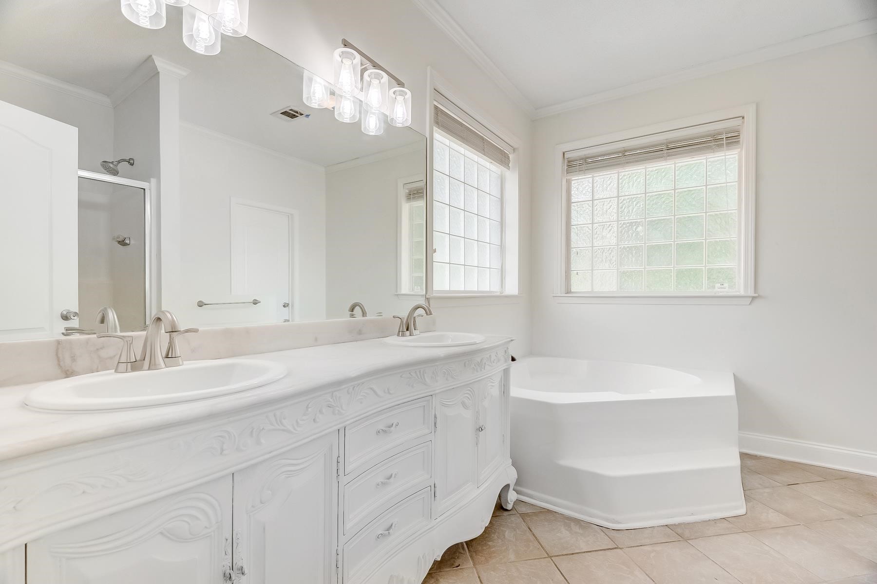 16741 Highway 69 Warren, TX 77664 - Photo 12 of 24 a bathroom with a double vanity sink mirror and bathtub