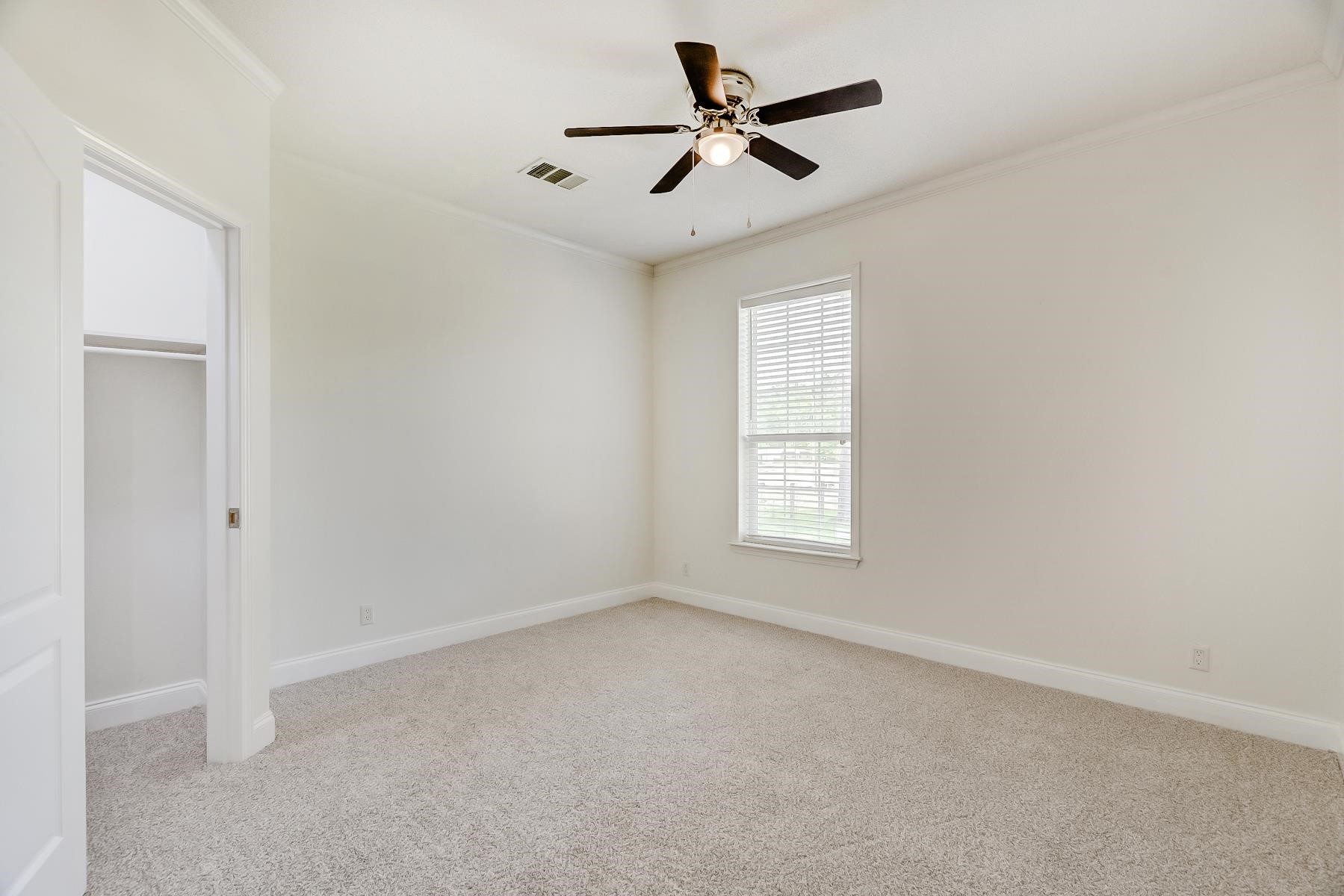 16741 Highway 69 Warren, TX 77664 - Photo 16 of 24 an empty room with a window and a fan