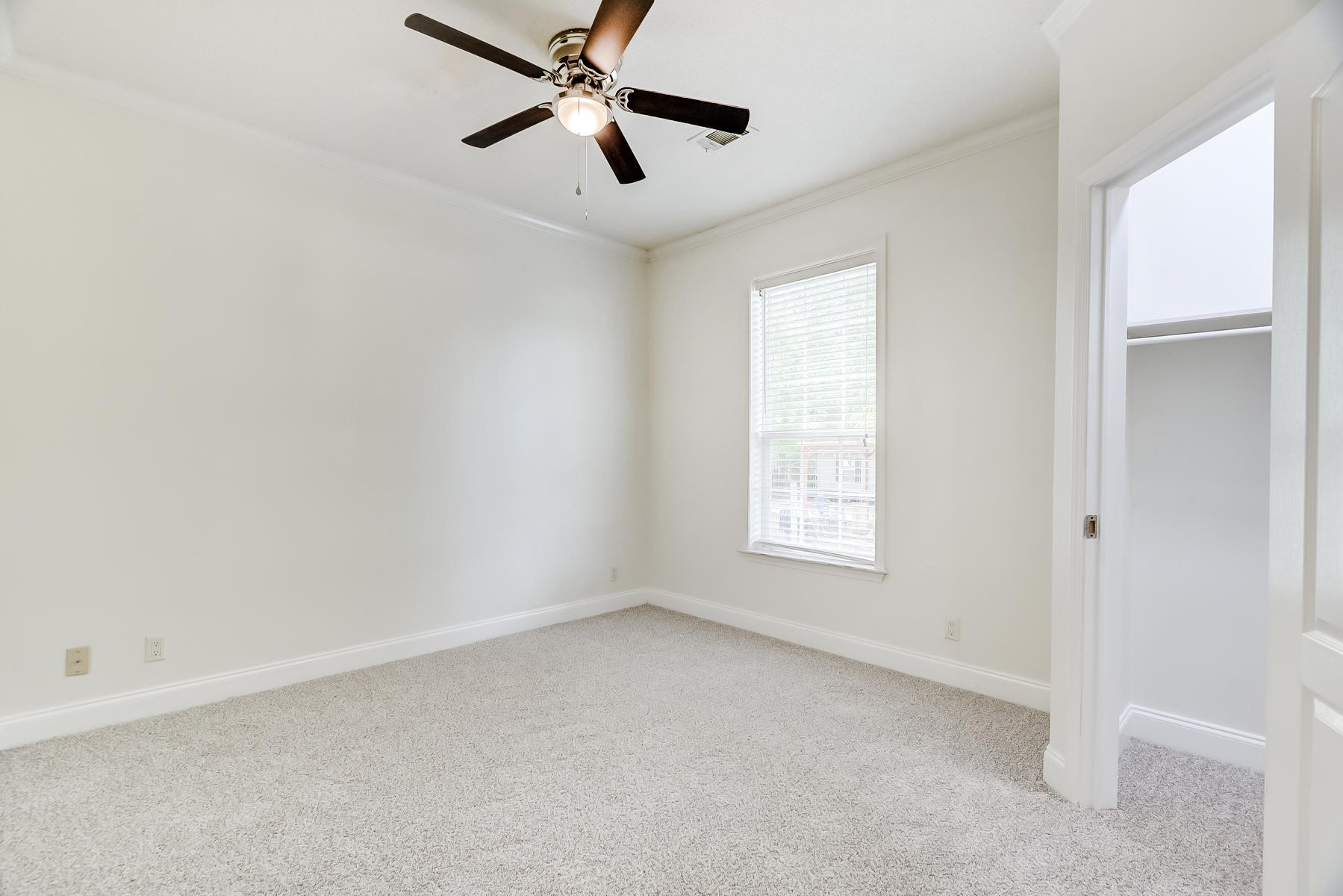 16741 Highway 69 Warren, TX 77664 - Photo 17 of 24 an empty room with a window and a fan