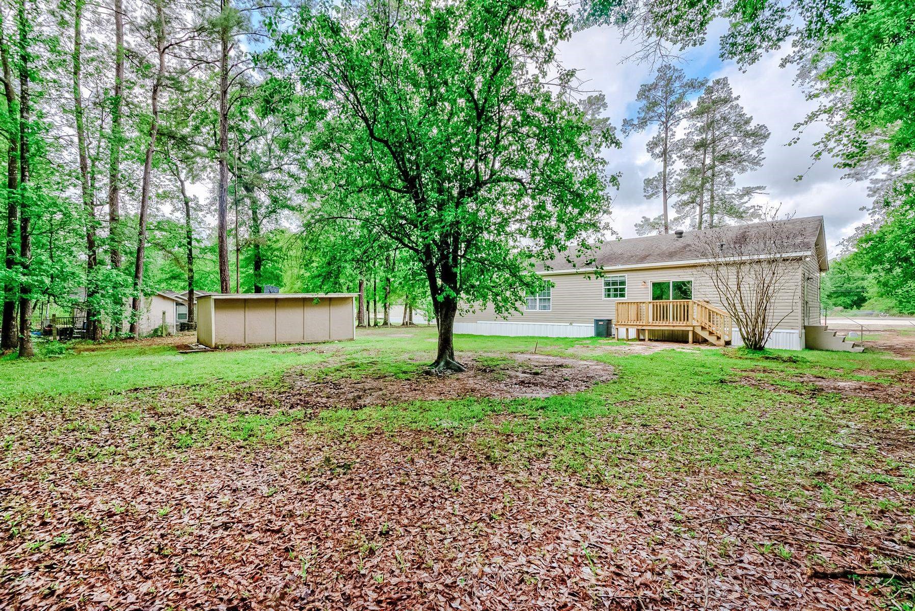 16741 Highway 69 Warren, TX 77664 - Photo 22 of 24 a front view of a house with yard and green space