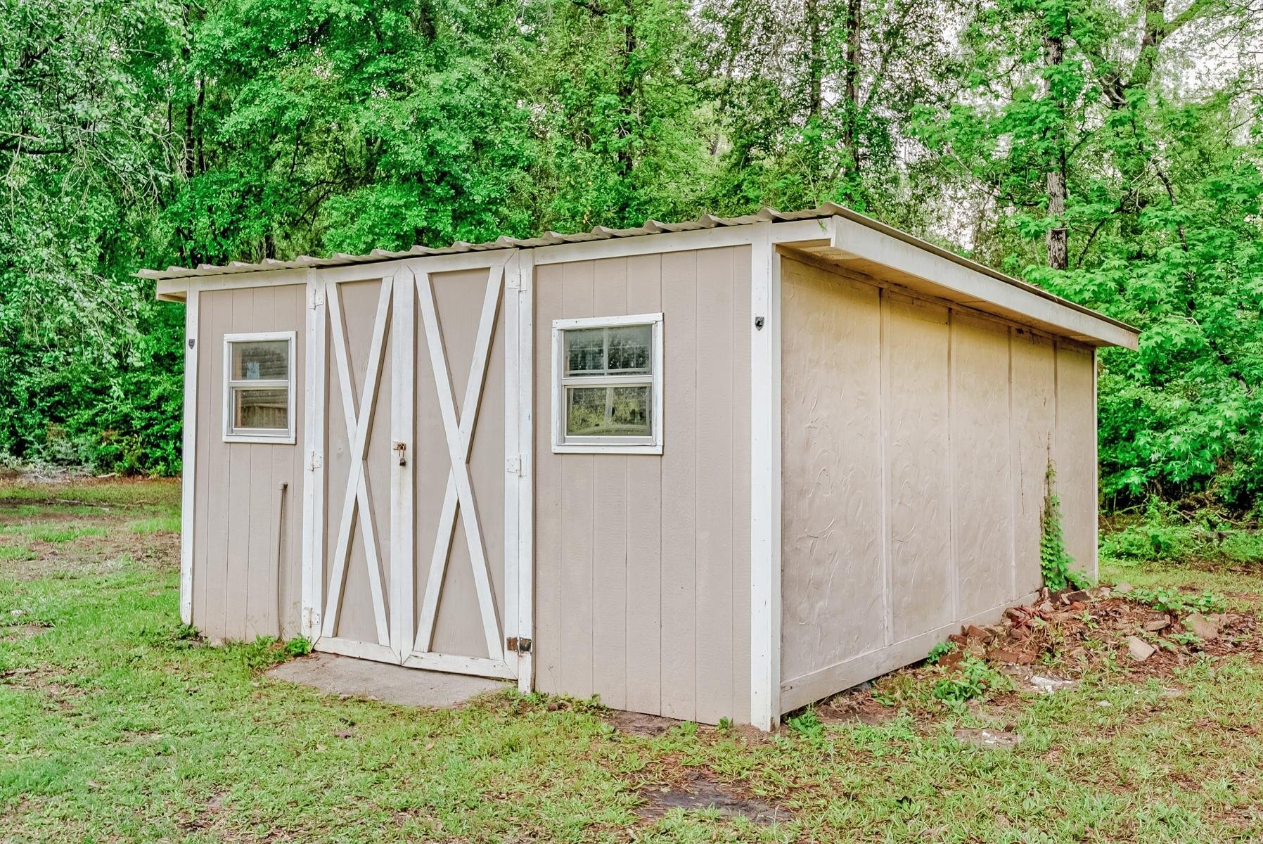 16741 Highway 69 Warren, TX 77664 - Photo 23 of 24 a view of a backyard with barn