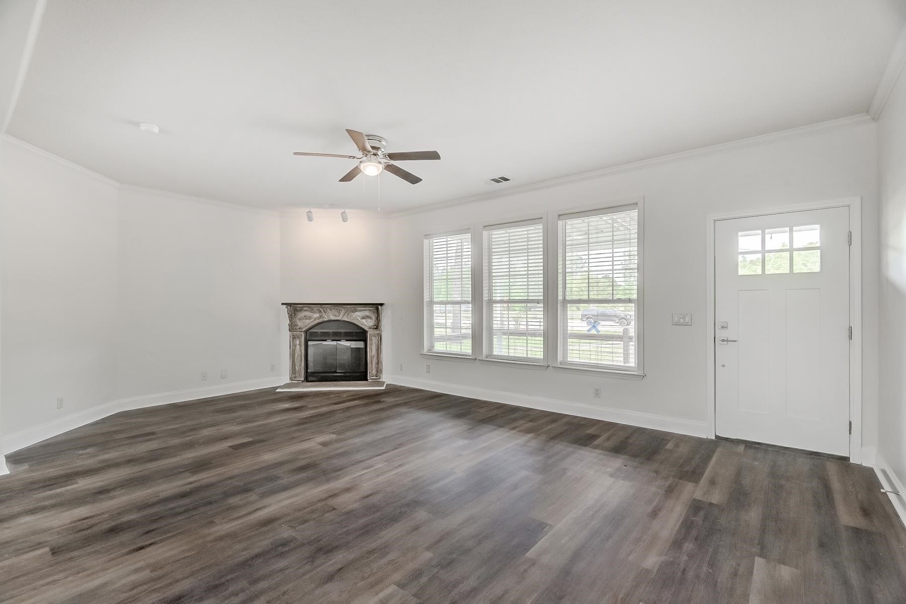 16741 Highway 69 Warren, TX 77664 - Photo 3 of 24 a view of an empty room with wooden floor and a window