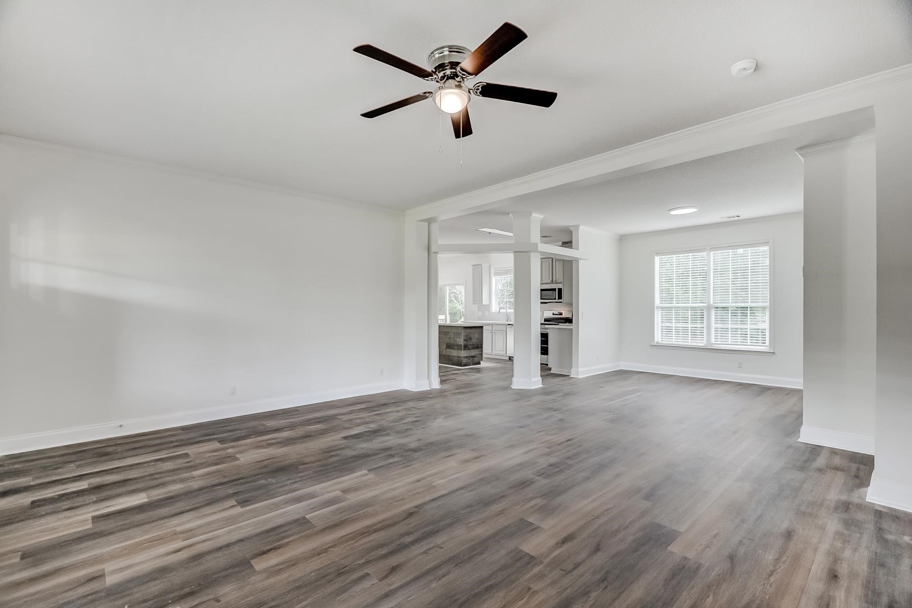 16741 Highway 69 Warren, TX 77664 - Photo 4 of 24 a view of an empty room with window and wooden floor