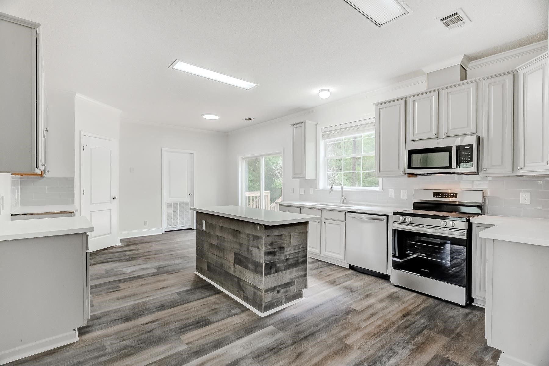 16741 Highway 69 Warren, TX 77664 - Photo 5 of 24 a kitchen with stainless steel appliances granite countertop a stove top oven a sink dishwasher and a refrigerator
