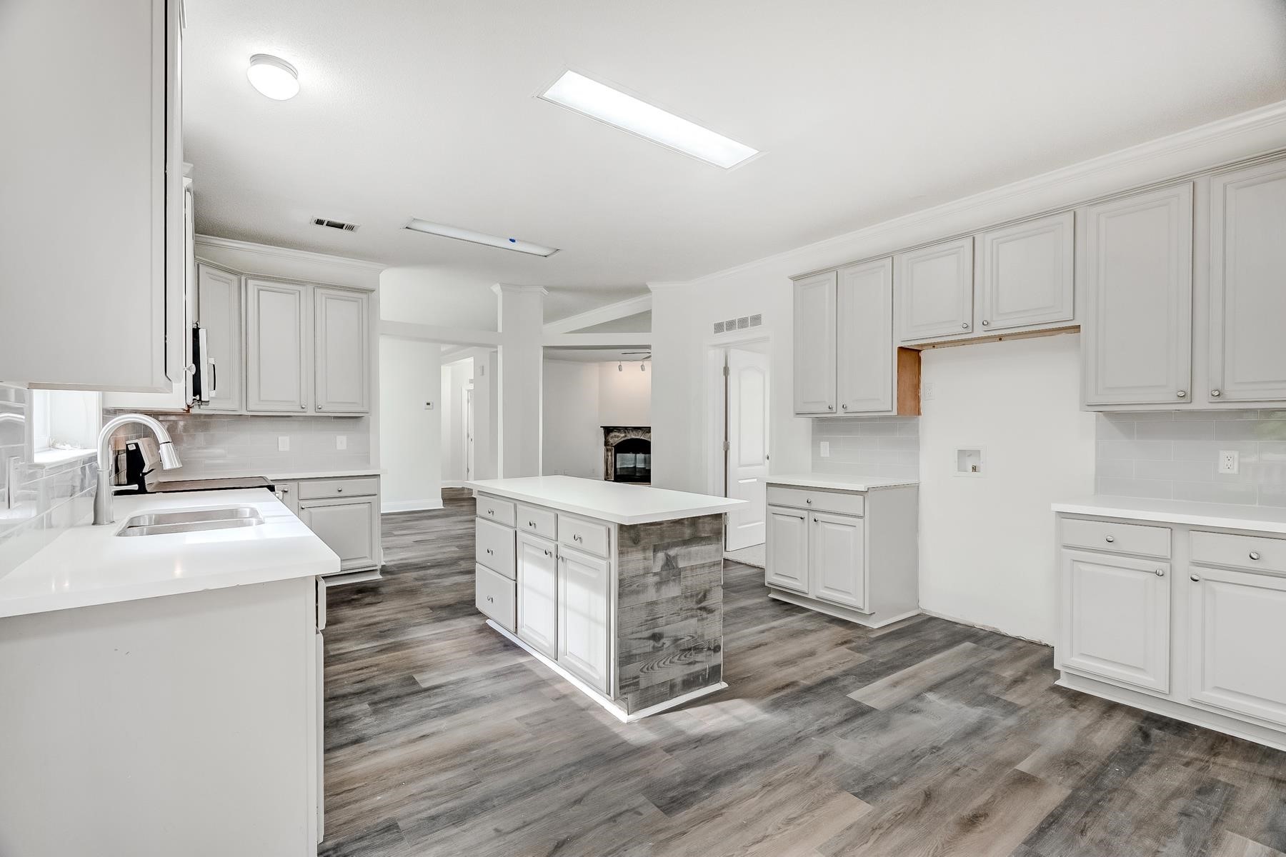 16741 Highway 69 Warren, TX 77664 - Photo 6 of 24 a kitchen with white cabinets and white appliances
