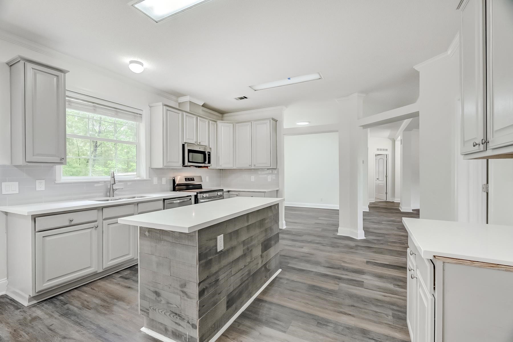 16741 Highway 69 Warren, TX 77664 - Photo 7 of 24 a kitchen with stainless steel appliances granite countertop a sink stove and refrigerator