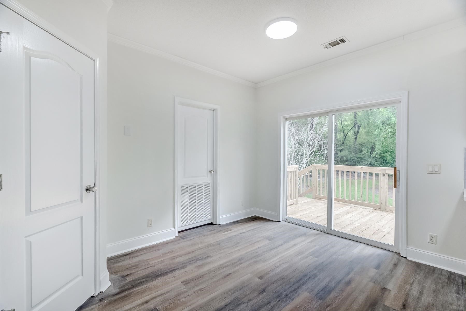 16741 Highway 69 Warren, TX 77664 - Photo 9 of 24 an empty room with wooden floor and windows