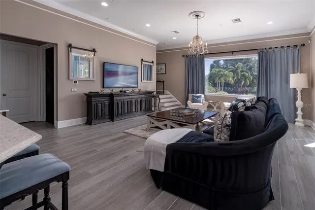 a living room with furniture a clock and a fireplace