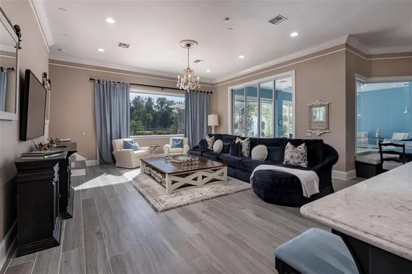 a spacious bedroom with a bed couch and window