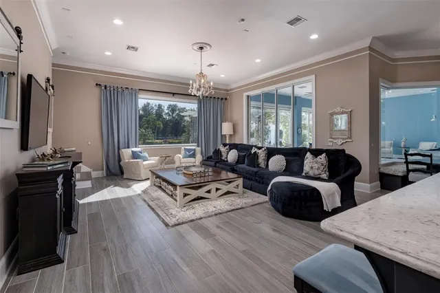 a spacious bedroom with a bed couch and window