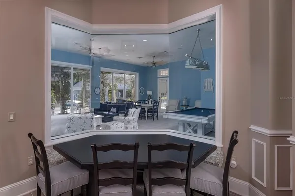 an aerial view of a house with a swimming pool patio and outdoor seating