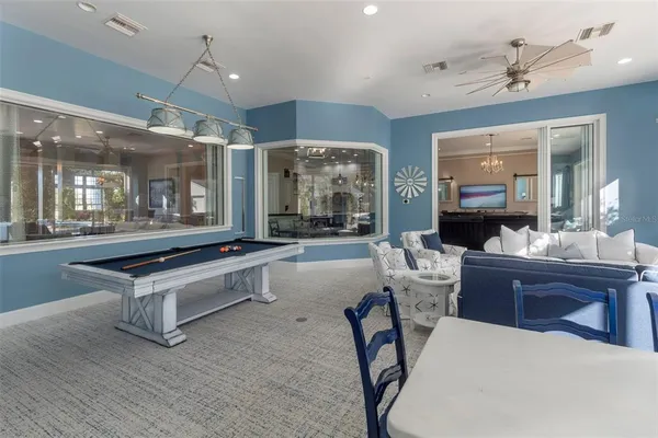 a view of a house with swimming pool and sitting area