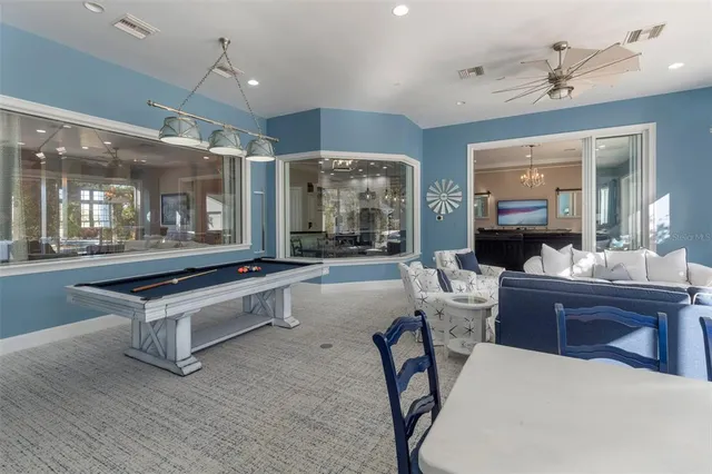 a view of a house with swimming pool and sitting area