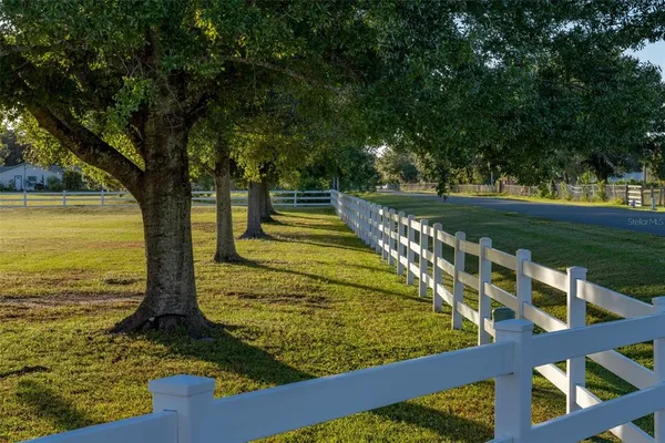 a front view of a house with porch and garden