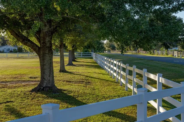 a front view of a house with porch and garden