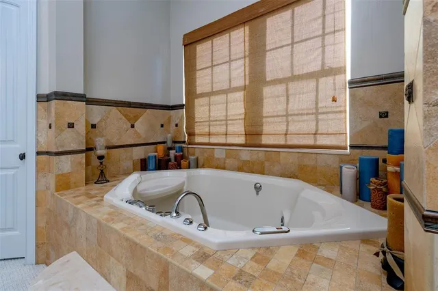 a spacious bedroom with a bed and a flat screen tv