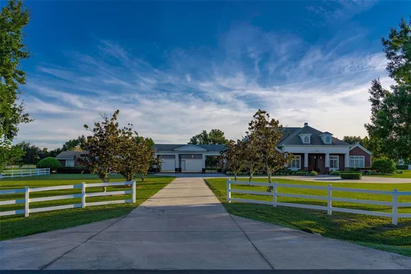 a front view of a house with a garden and yard