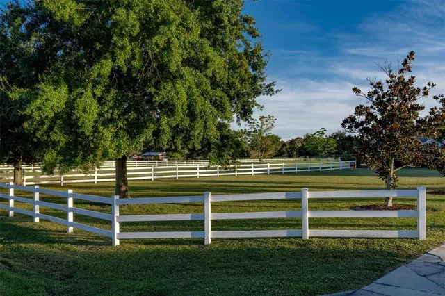 an aerial view of a house with outdoor space and lake view