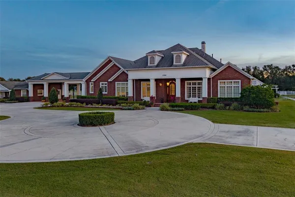 a view of a dining room with furniture wooden floor and chandelier