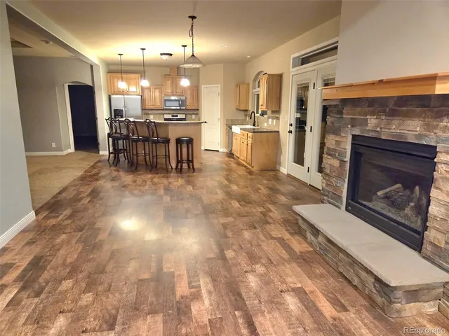 an empty room with windows and chandelier fan