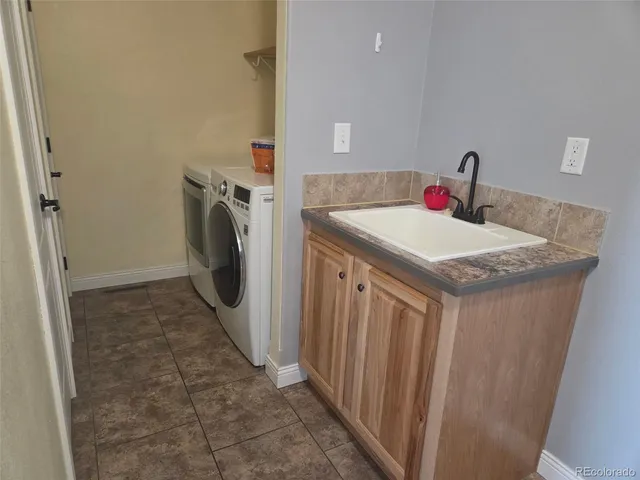 a view of a wooden house with a yard and a large tree