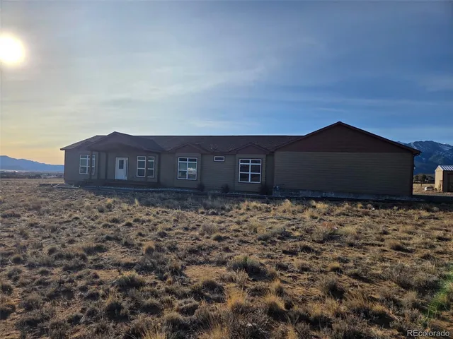 a kitchen with stainless steel appliances granite countertop a dining table chairs sink and cabinets