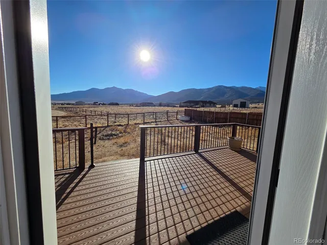 an empty room with a ceiling fan and a window