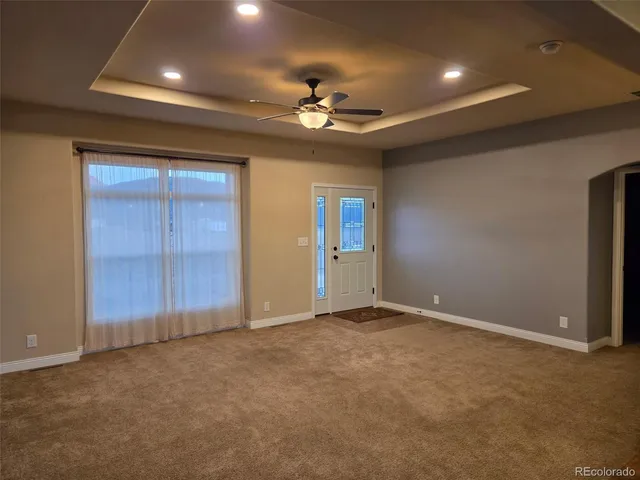a spacious bathroom with a granite countertop sink a toilet and a mirror