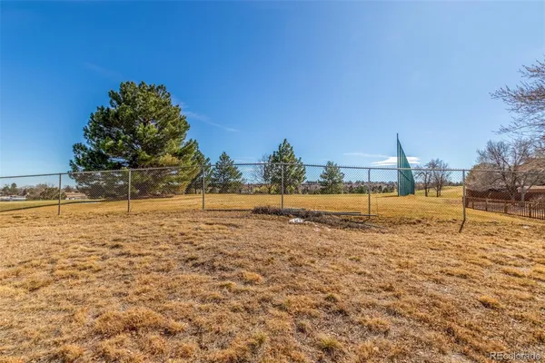 a view of a yard with wooden fence
