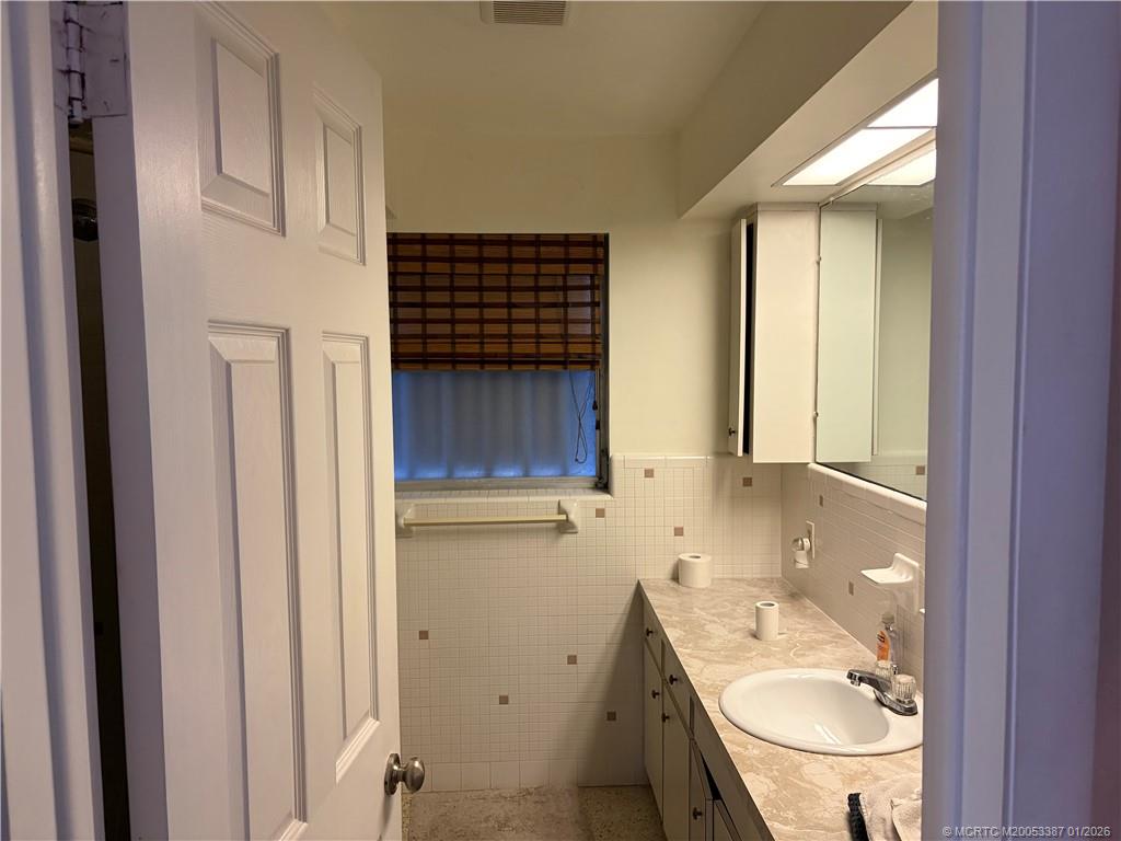 1346 Northwest Pine Ridge Trail Stuart, FL 34994 - Photo 11 of 21 a bathroom with a granite countertop sink toilet and shower