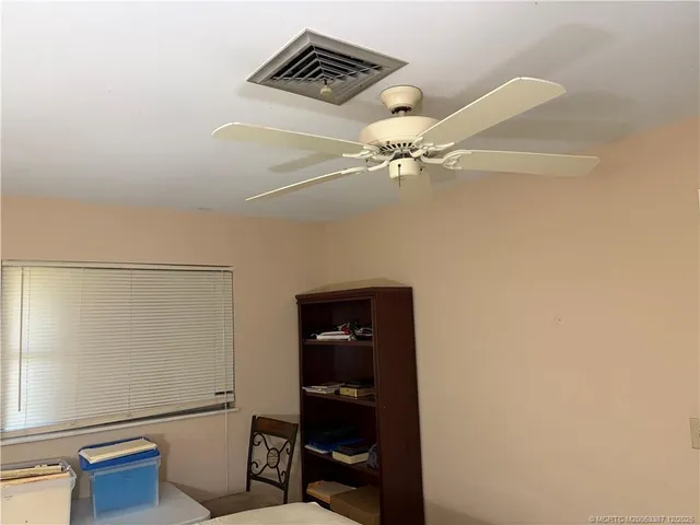 a view of an empty room with a fan