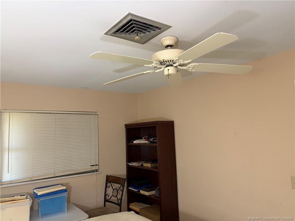 1346 Northwest Pine Ridge Trail Stuart, FL 34994 - Photo 12 of 21 a view of an empty room with a fan