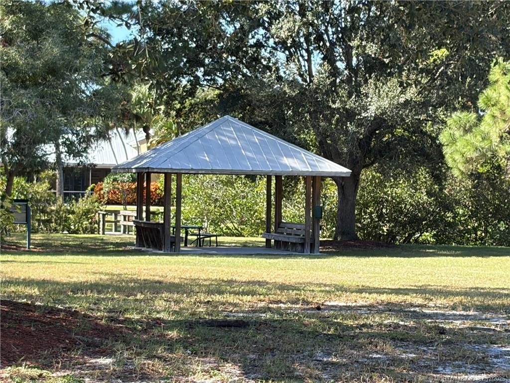 1346 Northwest Pine Ridge Trail Stuart, FL 34994 - Photo 20 of 21 a view of a house with a yard