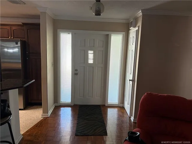 a view of a hallway with wooden floor and furniture