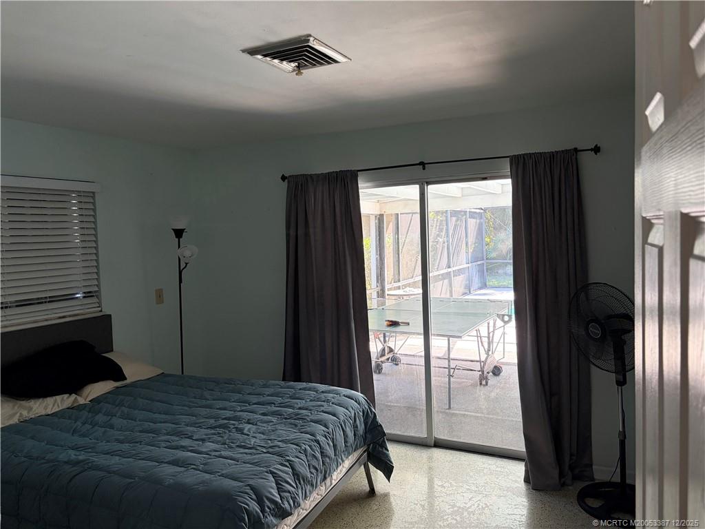 1346 Northwest Pine Ridge Trail Stuart, FL 34994 - Photo 9 of 21 a bedroom with a bed and a window